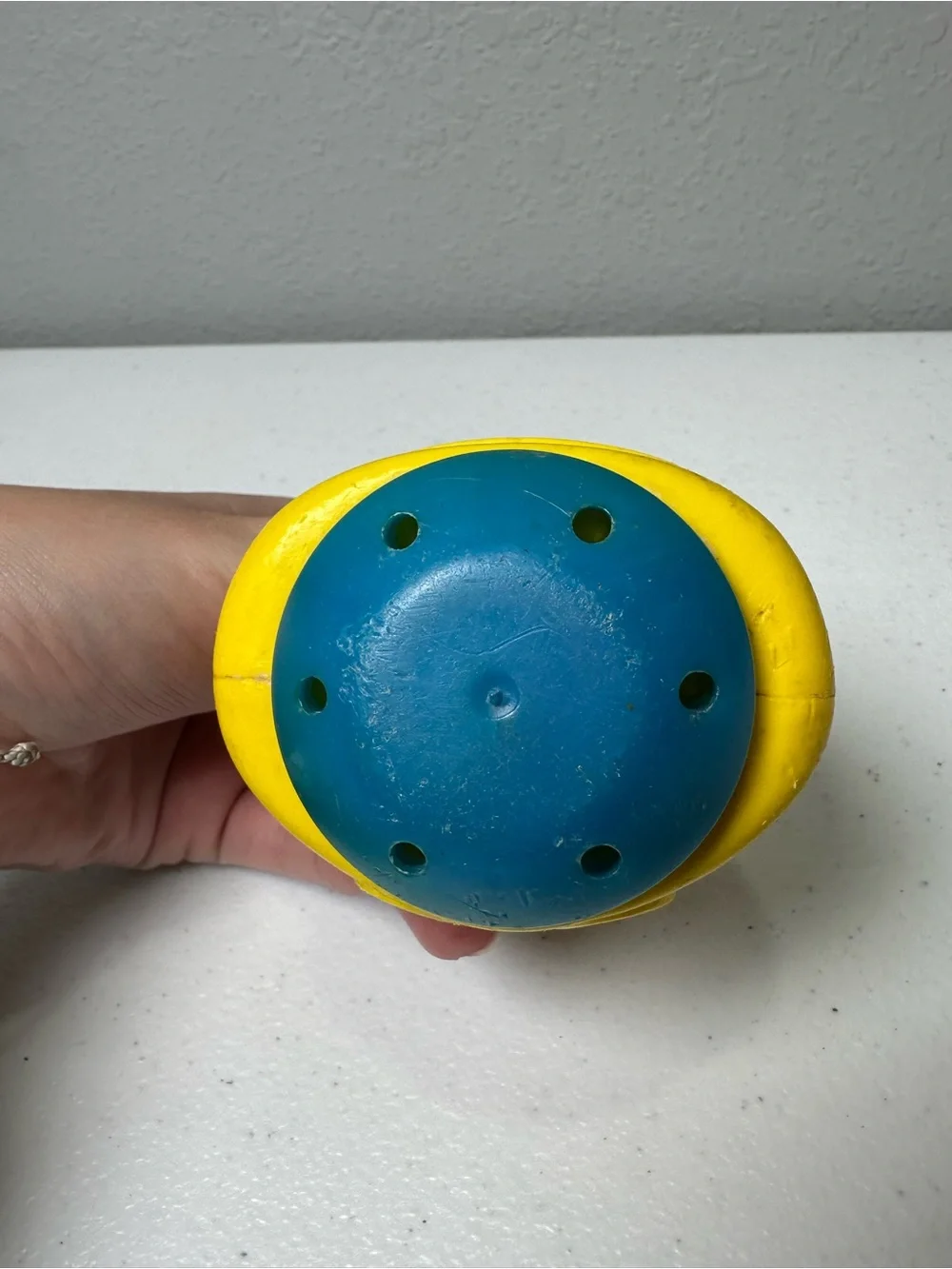 Fisher-Price Yellow Roly-Body Toy with Peach Face and Blue Base